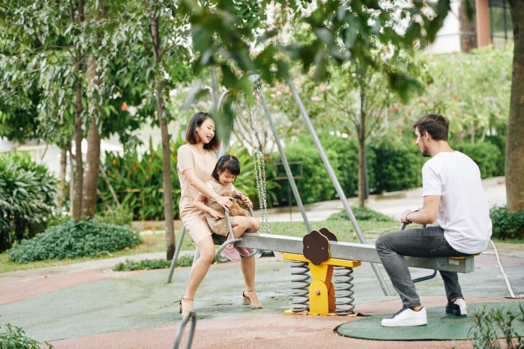 Family playing on seesaw